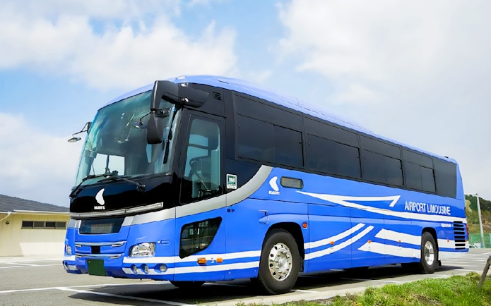 Kansai Airport Limousine Bus parked at terminal with passengers boarding.
