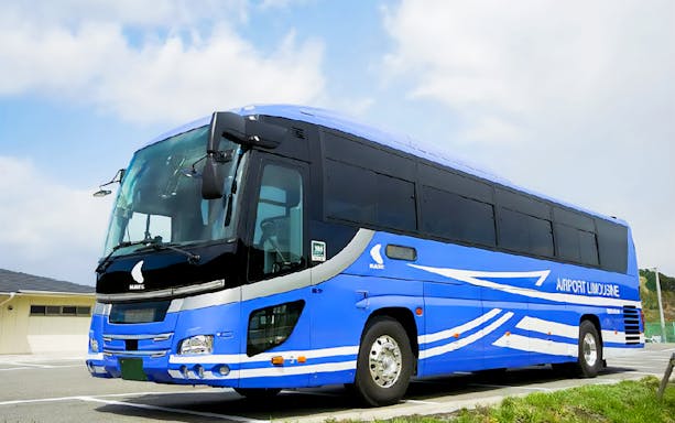 Kansai Airport Limousine Bus parked at terminal with passengers boarding.