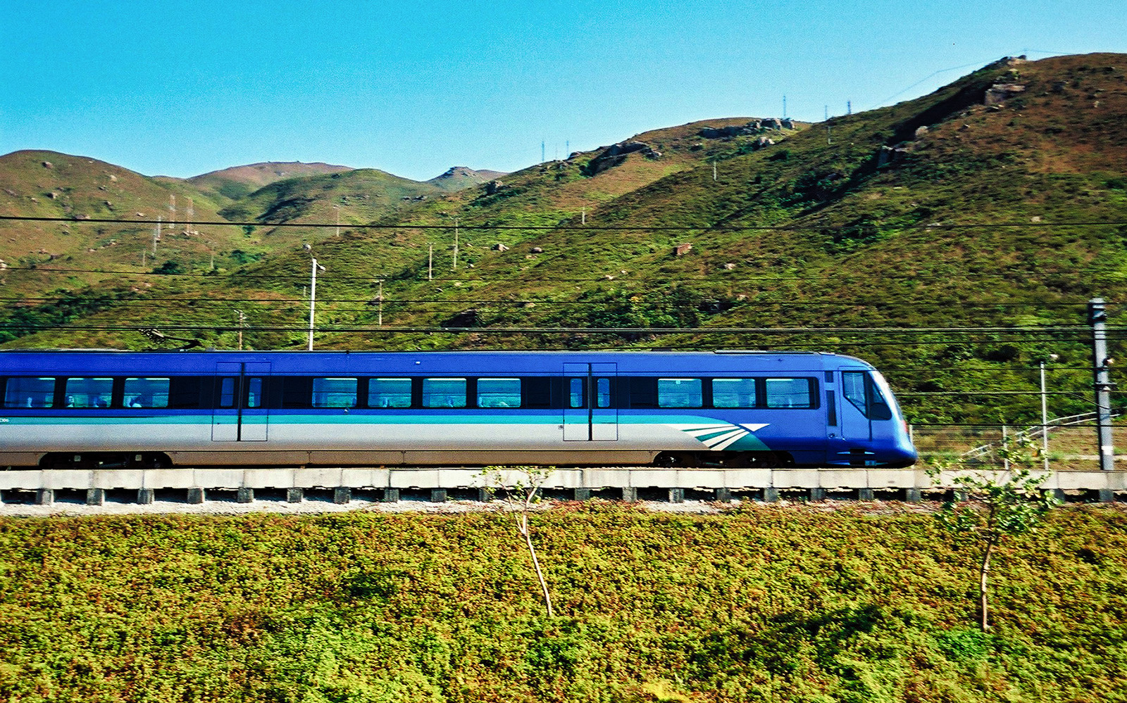 Hong Kong Airport Express train interior with passengers traveling to city center.