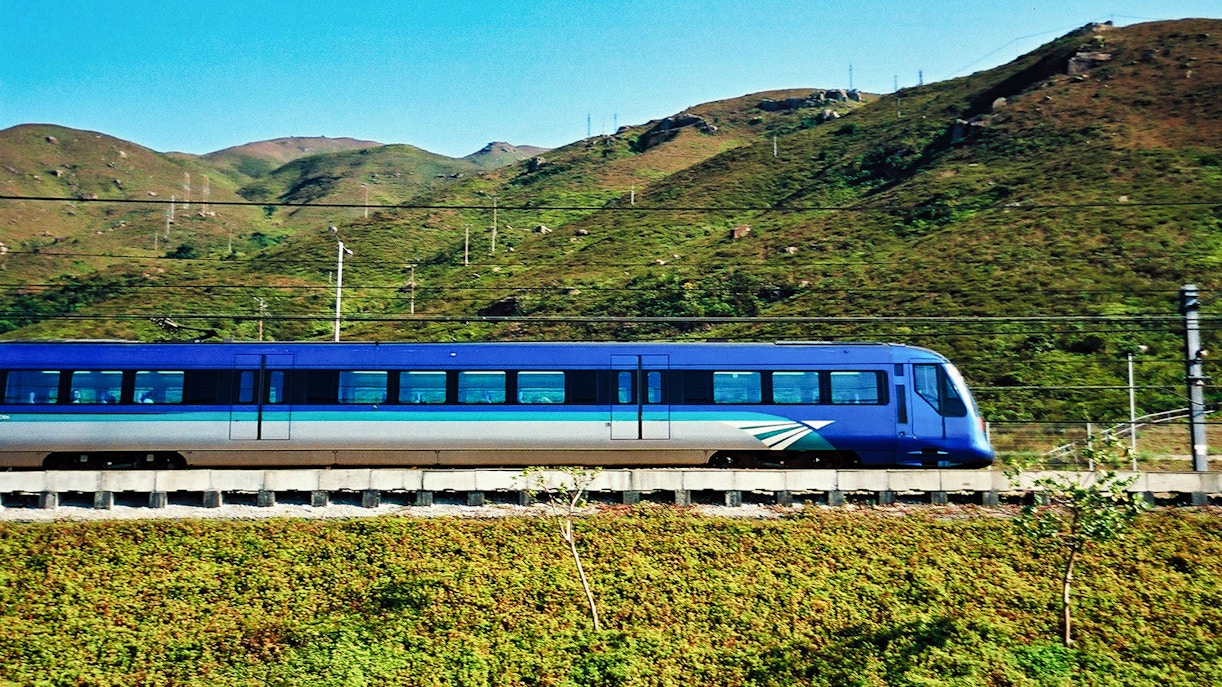 Hong Kong Airport Express train interior with passengers traveling to city center.