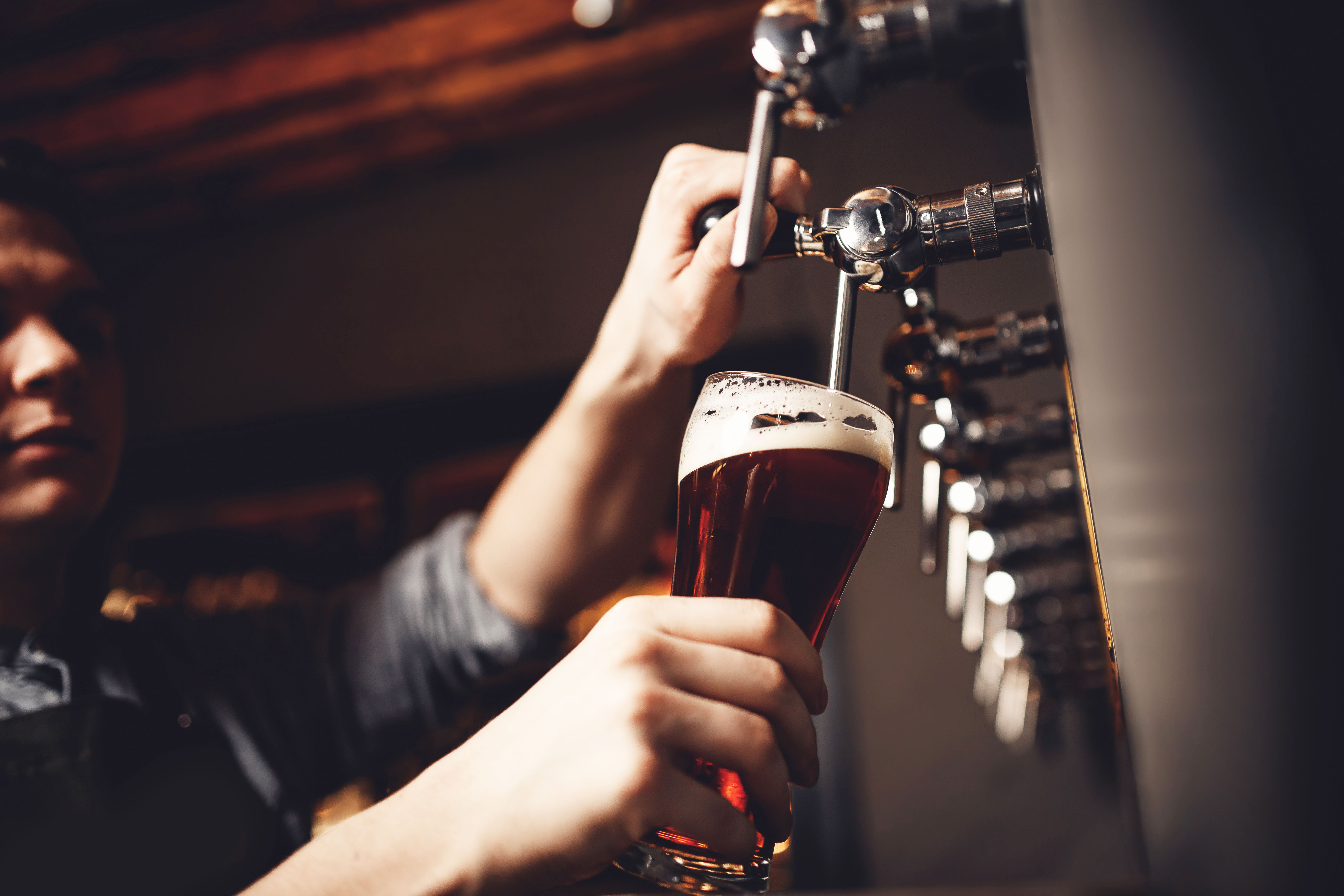 Pouring beer from tap at Tiger Brewery tour.