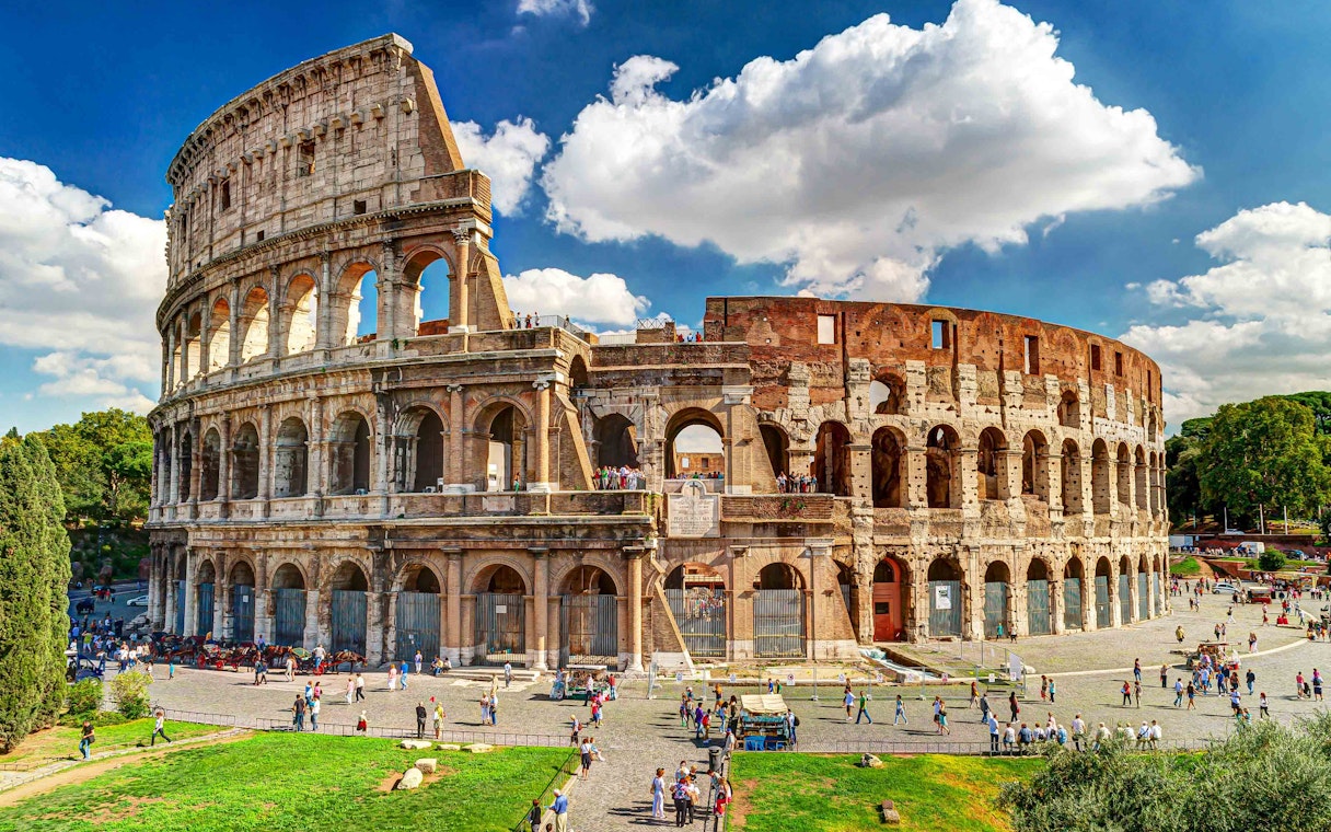 Colosseum exterior with visitors, Rome, part of twilight tour with Imperial Forums.