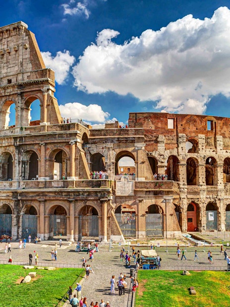 Colosseum exterior with visitors, Rome, part of twilight tour with Imperial Forums.