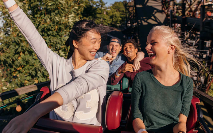 People enjoying a roller coaster ride at a theme park in Barcelona.
