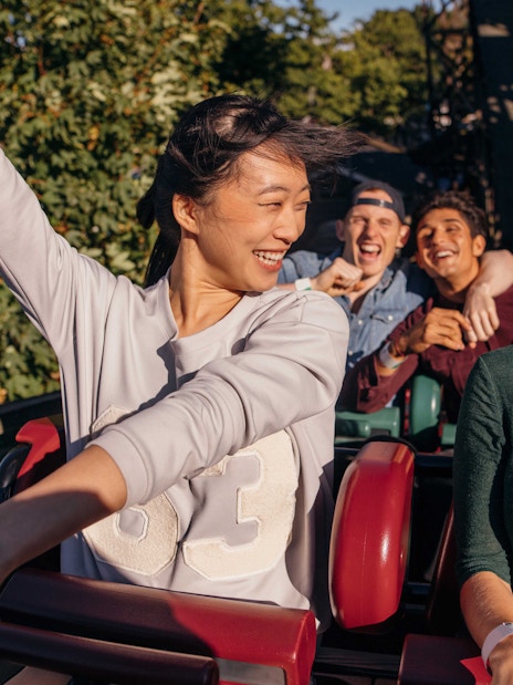 People enjoying a roller coaster ride at a theme park in Barcelona.