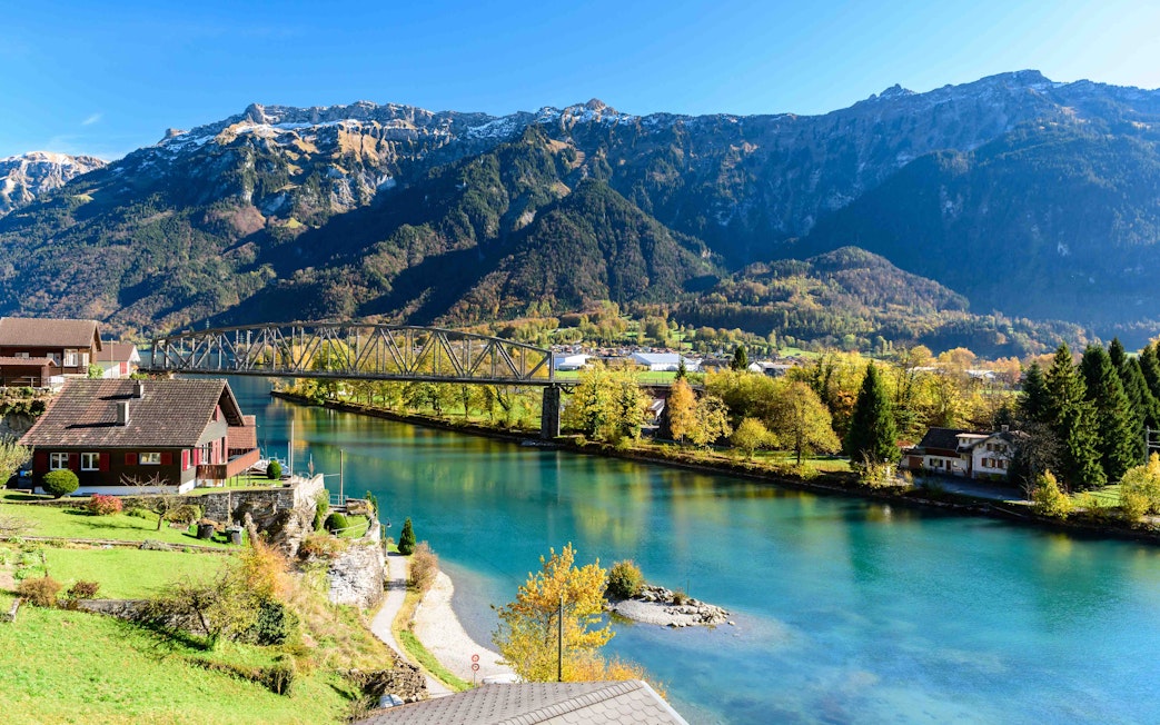 Interlaken river view with mountains and bridge in Switzerland.