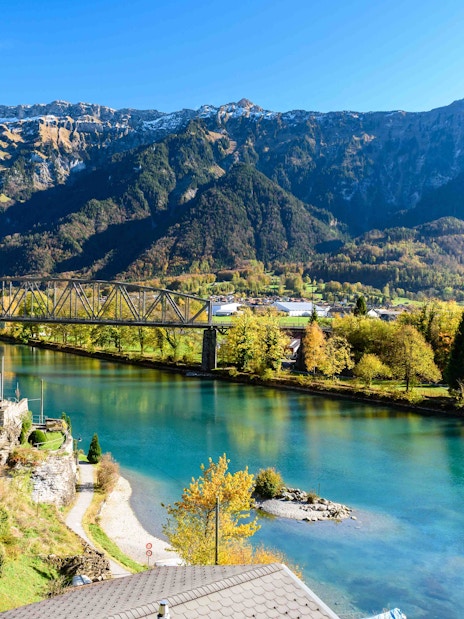Interlaken river view with mountains and bridge in Switzerland.