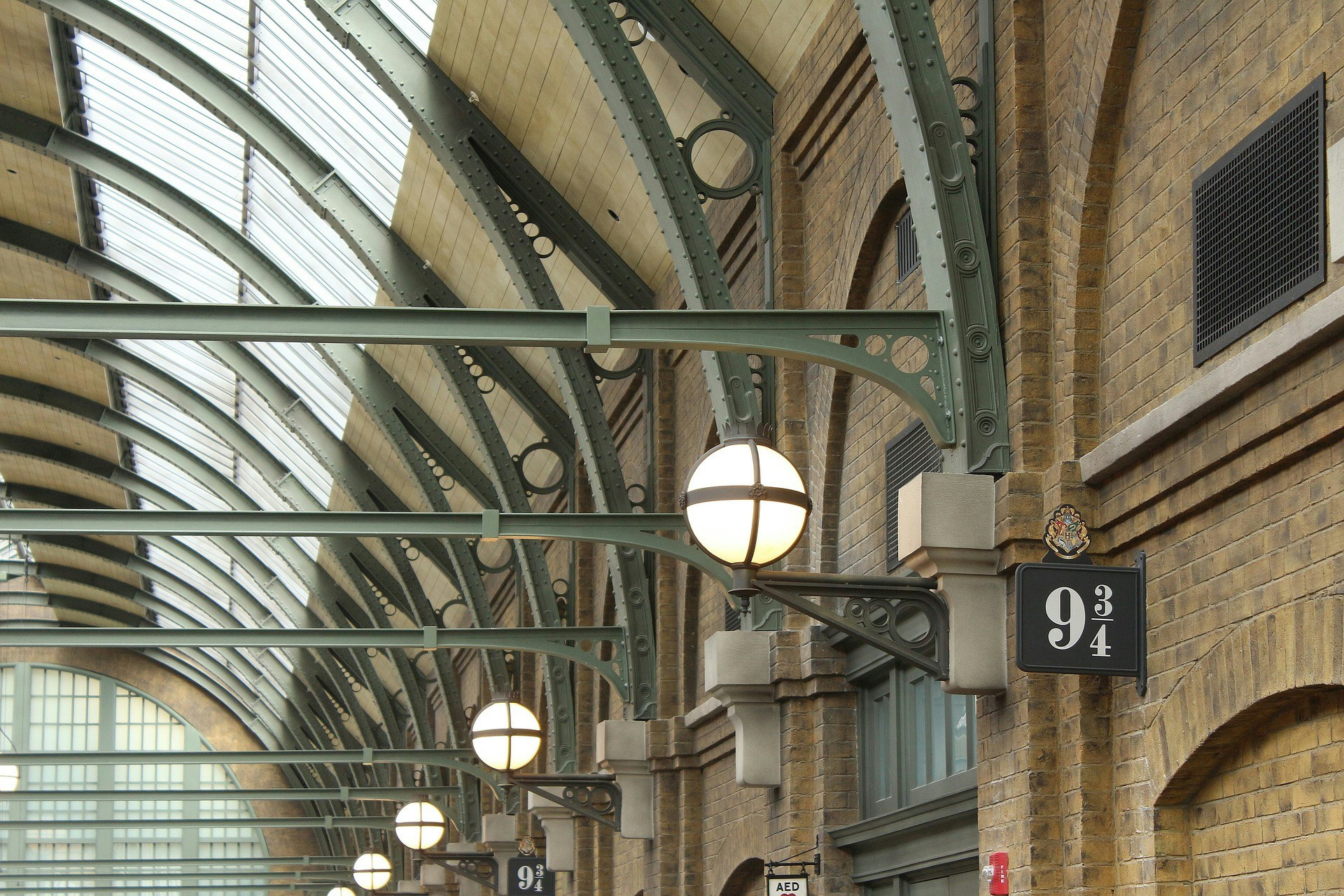 Platform 9¾ sign at Harry Potter Studio, London, with luggage trolley halfway through the wall.