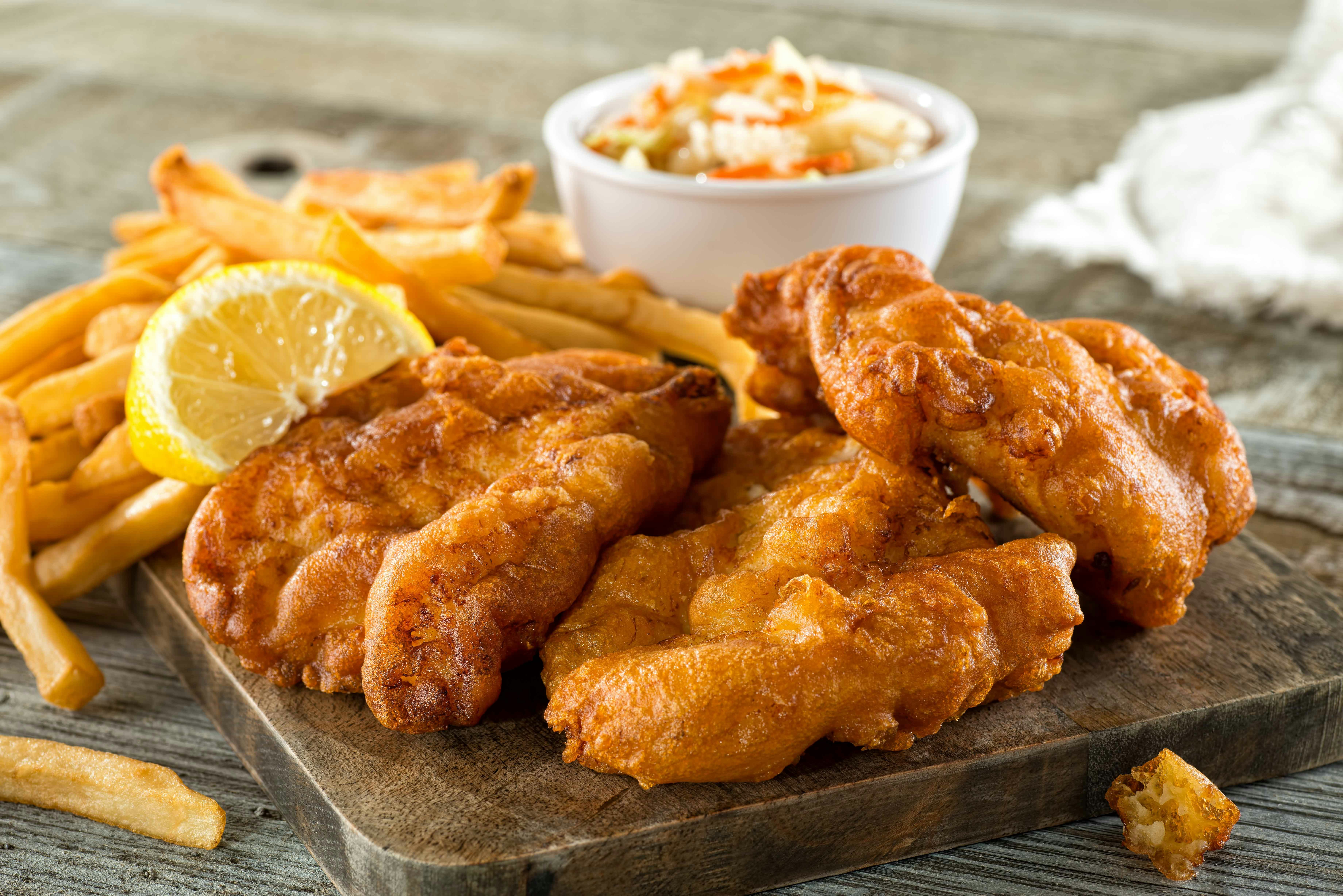 Fish and chips with lemon and coleslaw at Toad Hall Restaurant, Disneyland Paris.