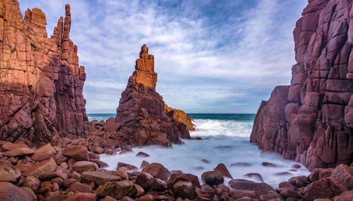 Cape Woolamai coastline view from Phillip Island cruise, featuring rugged cliffs and ocean waves.