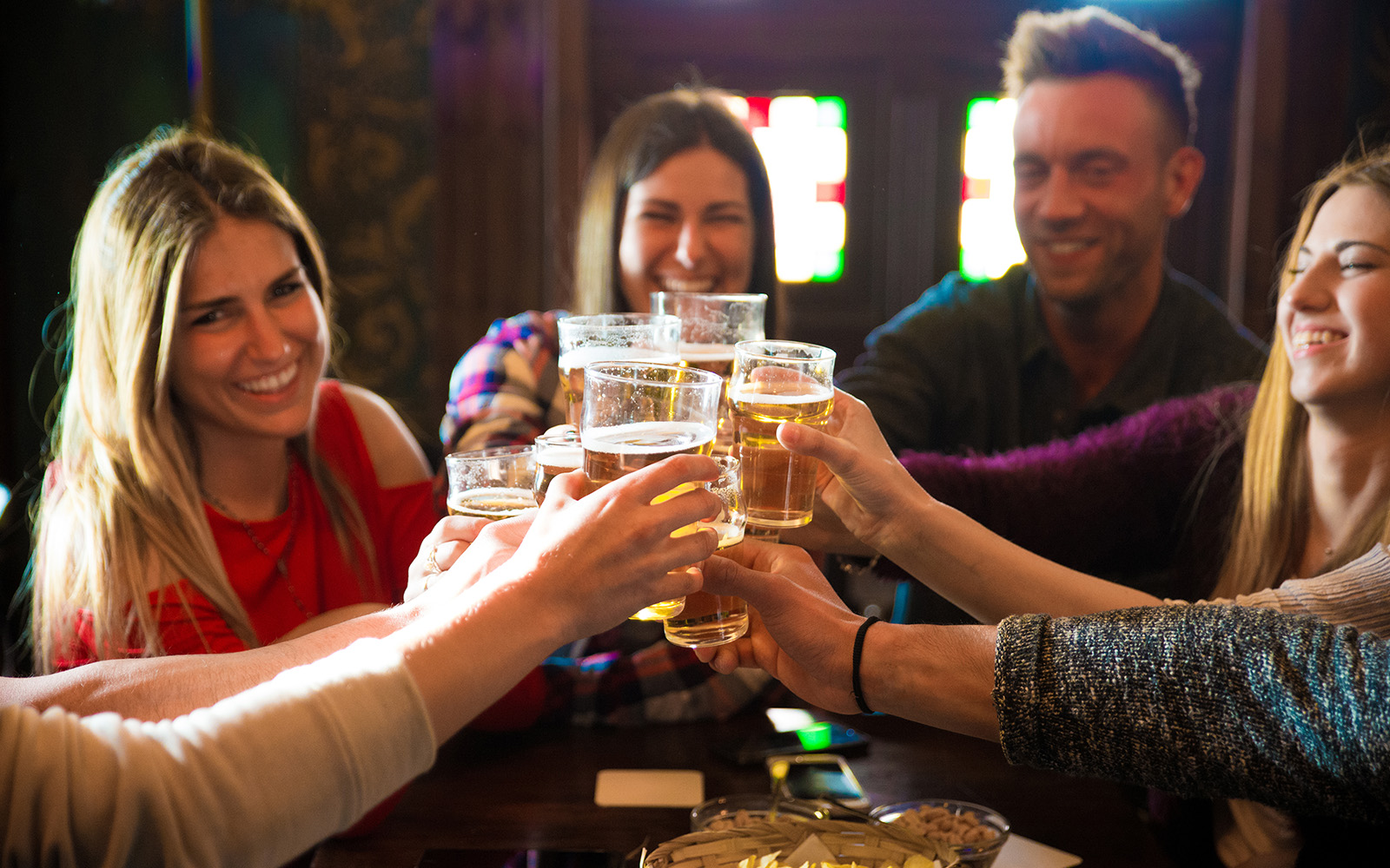 People toasting with drinks at a disco club in Amsterdam during New Year celebration.