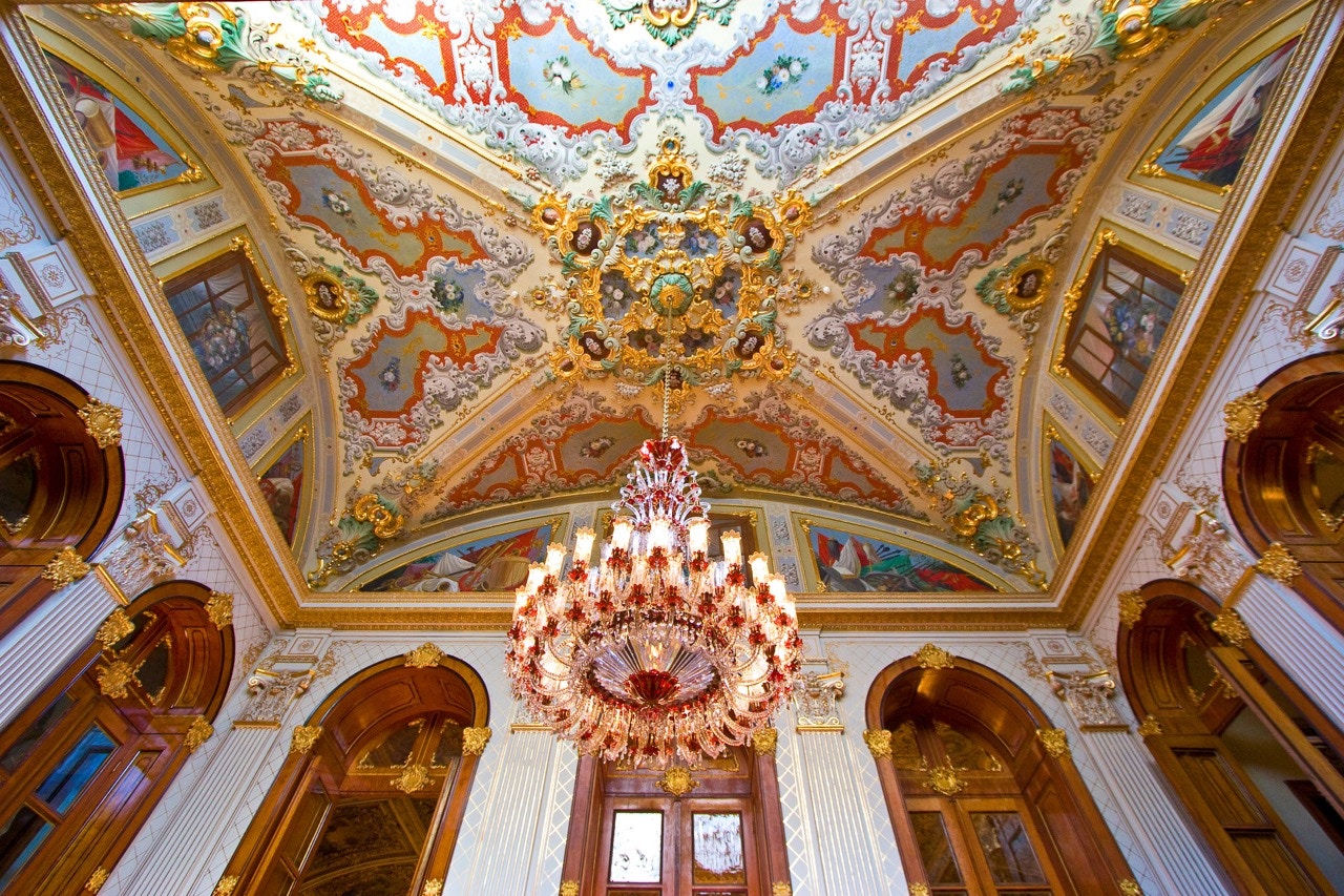 Dolmabahce Palace Muayede Hall with ornate chandeliers and intricate ceiling details in Istanbul, Turkey.