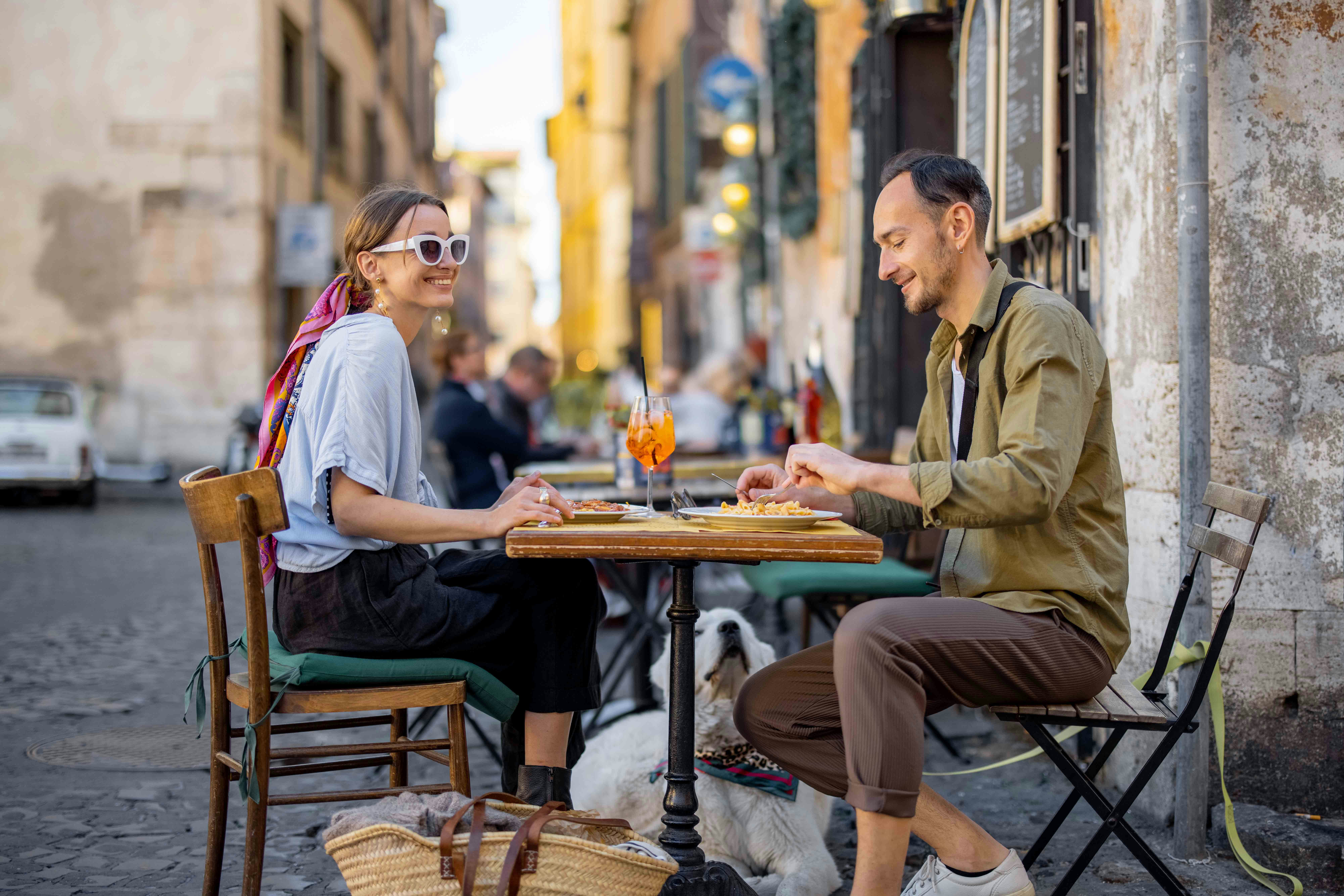 Tourists enjoying a culinary experience in Rome, sampling local Italian dishes.