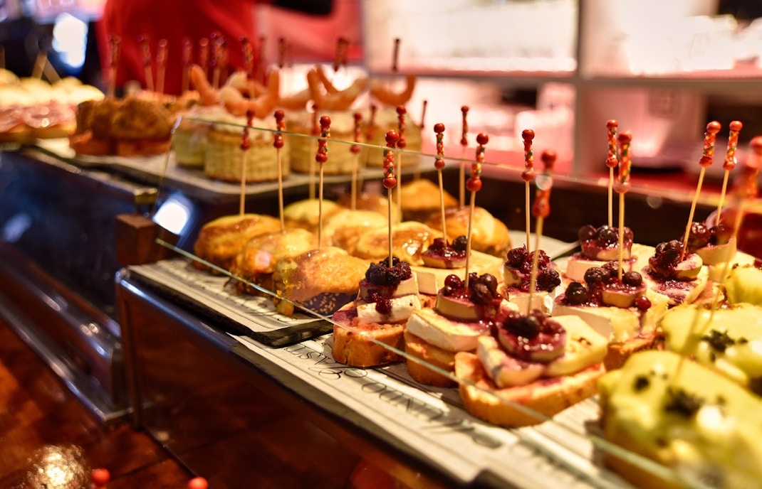 Cal Pep tapas bar interior with patrons enjoying traditional Spanish dishes in Barcelona.