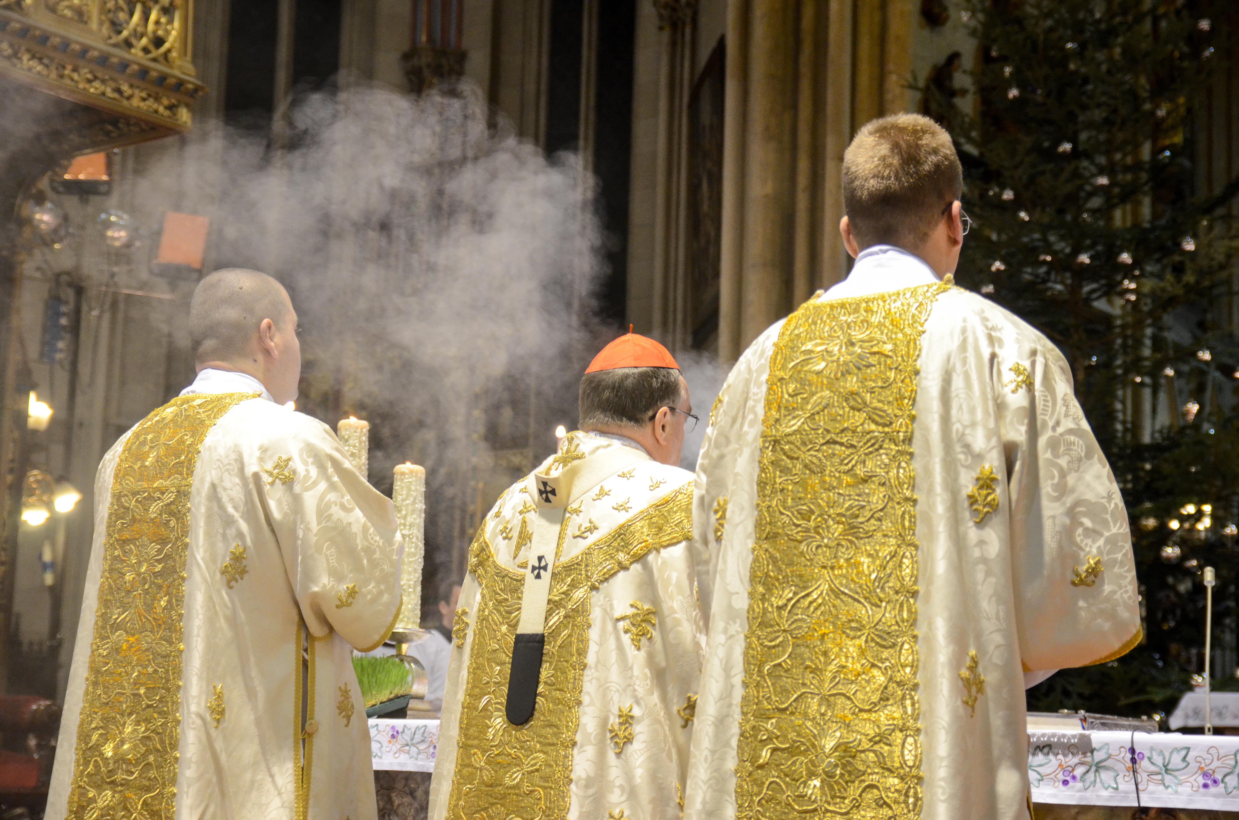 Clergy in ornate vestments during Midnight Mass at Milan Cathedral, Christmas in Milan.