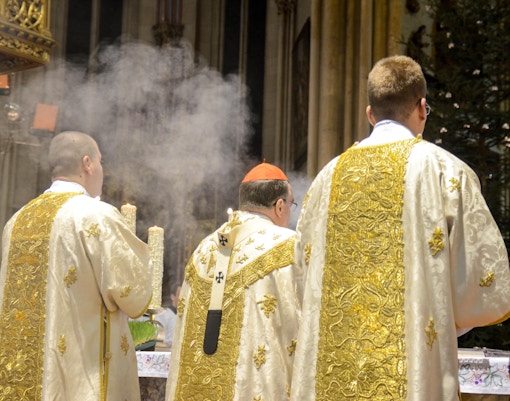 Clergy in ornate vestments during Midnight Mass at Milan Cathedral, Christmas in Milan.