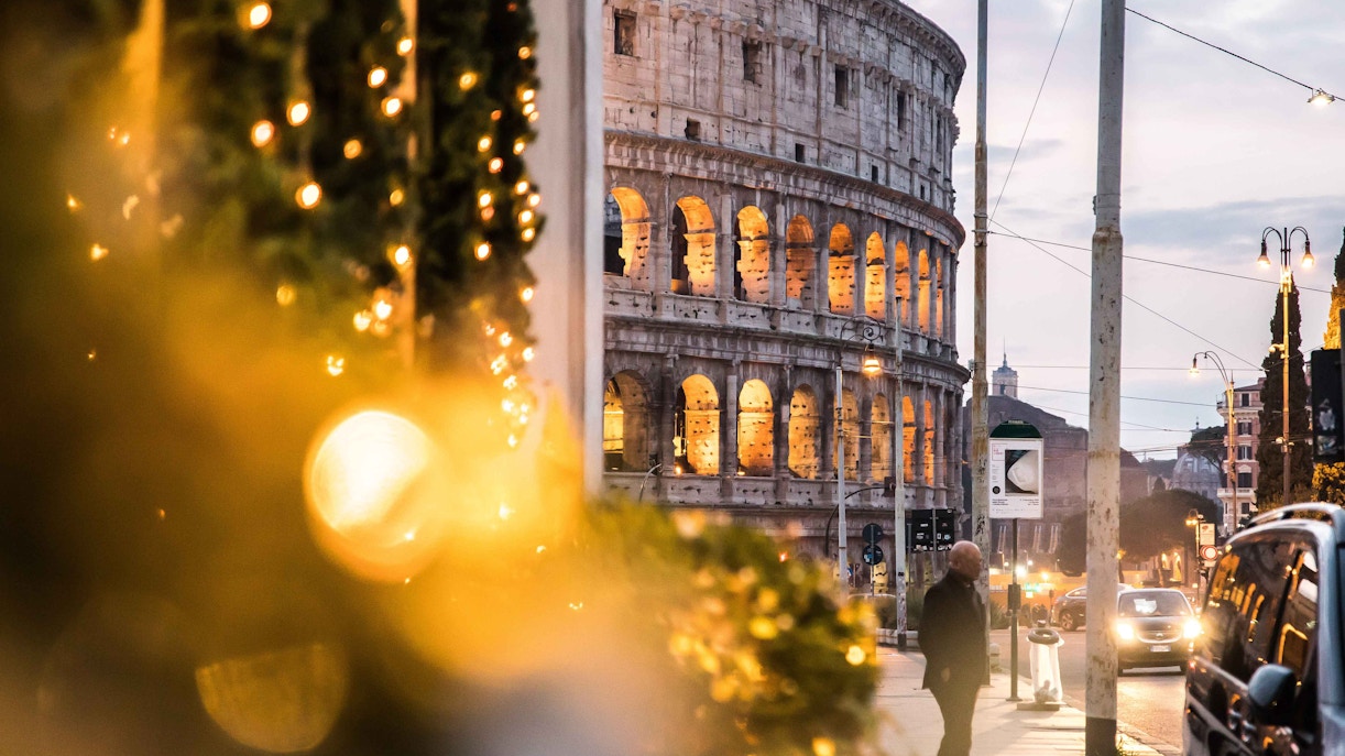 Colosseum in Rome with Christmas lights in foreground.