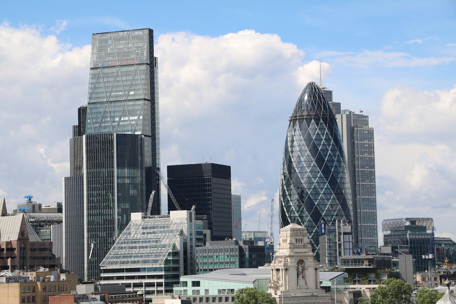 The Gherkin in London with surrounding cityscape.