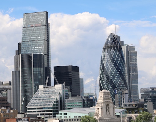 The Gherkin in London with surrounding cityscape.