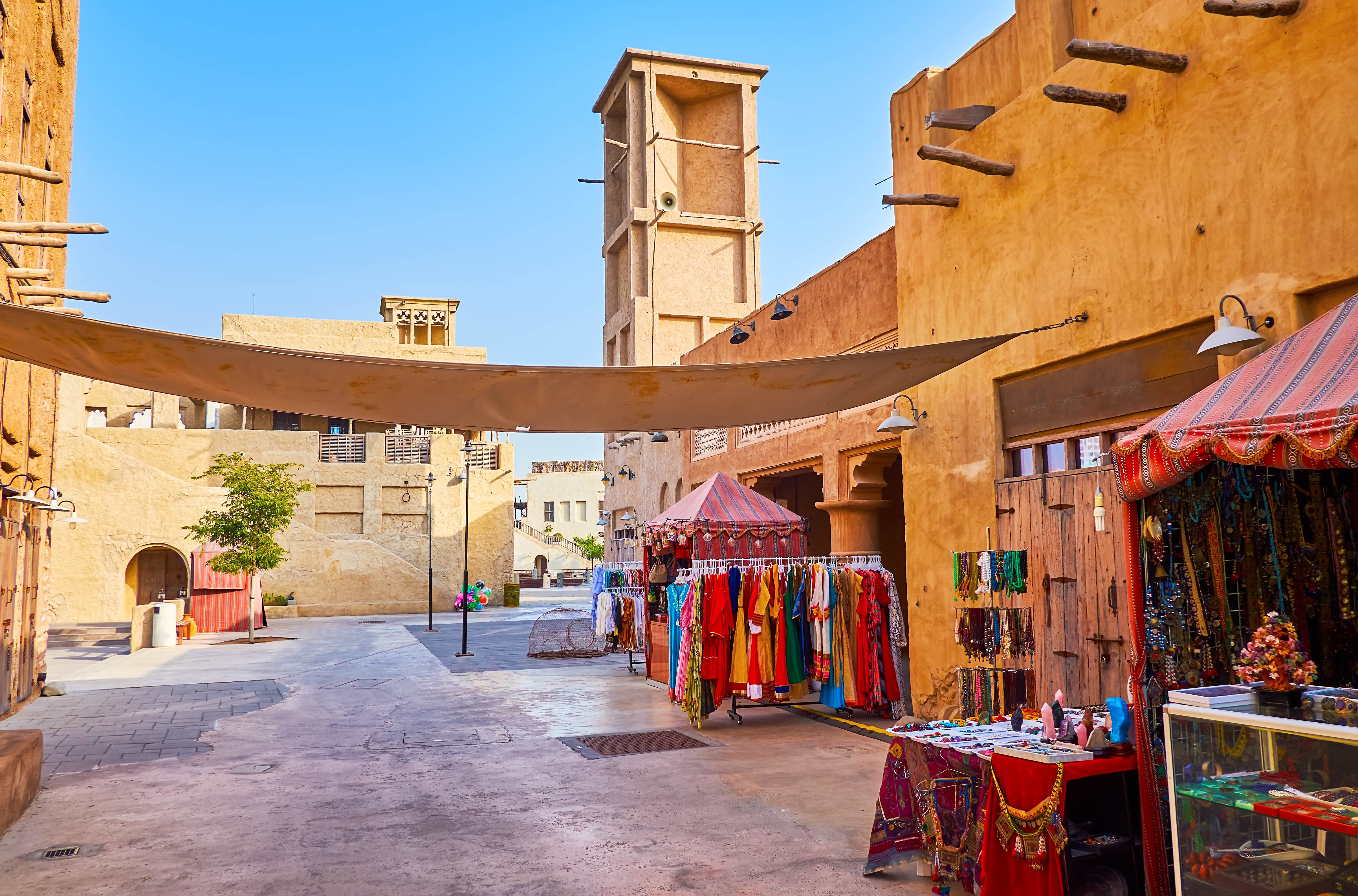 Heritage Village market stalls with traditional clothing and crafts in Dubai.