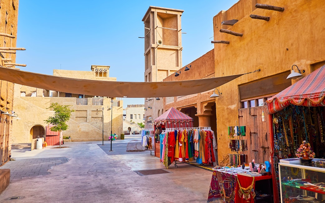 Heritage Village market stalls with traditional clothing and crafts in Dubai.