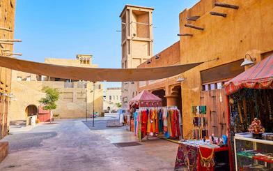 Heritage Village market stalls with traditional clothing and crafts in Dubai.