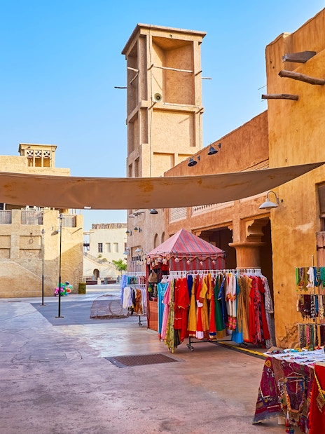Heritage Village market stalls with traditional clothing and crafts in Dubai.