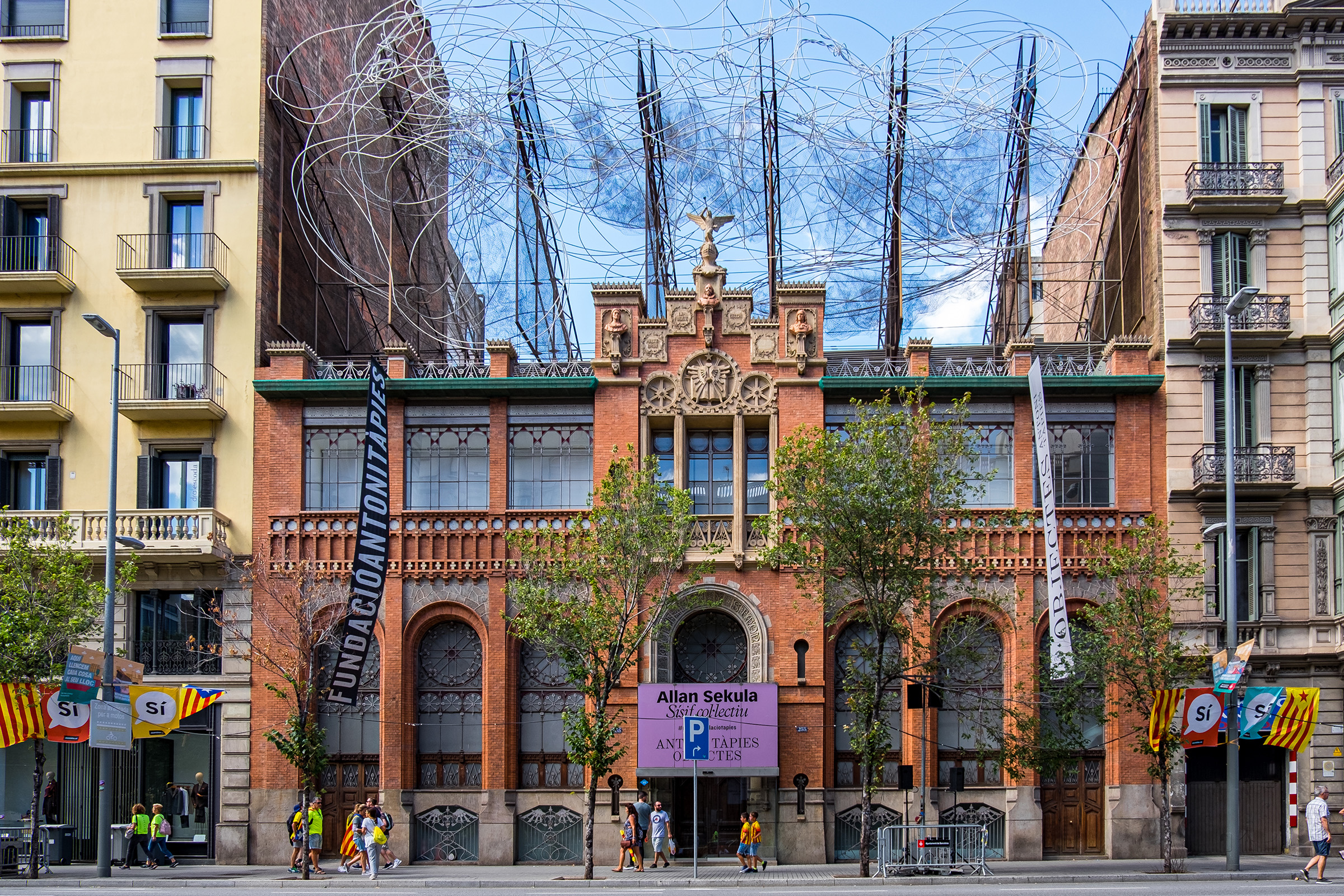 Fundació Antoni Tàpies building facade with wire sculpture on roof in Barcelona, Spain.