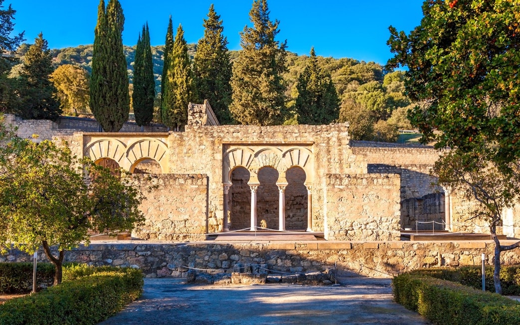 Medina Azahara ruins with arches and trees in Cordoba, Spain.