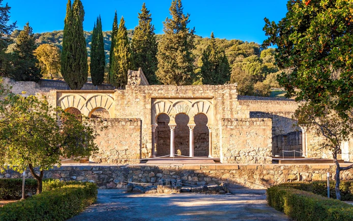 Medina Azahara ruins with arches and trees in Cordoba, Spain.