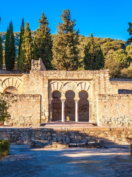 Medina Azahara ruins with arches and trees in Cordoba, Spain.
