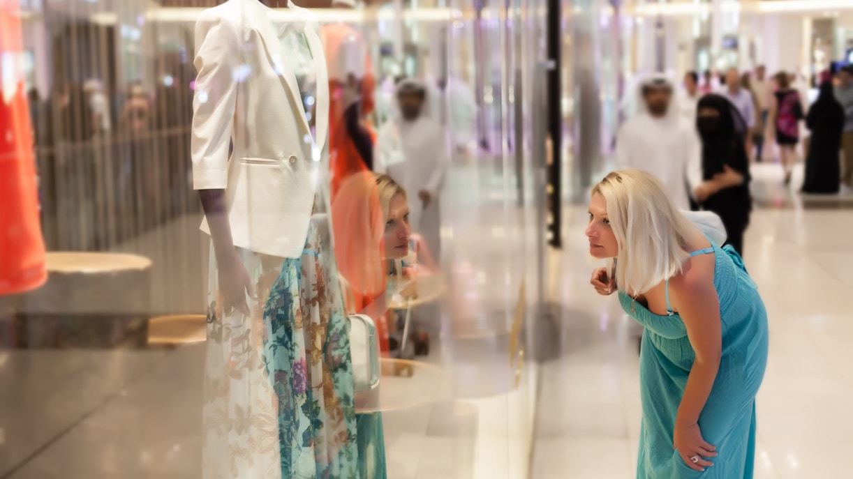 Shopper admiring fashion display at Mall of the Emirates, Dubai.