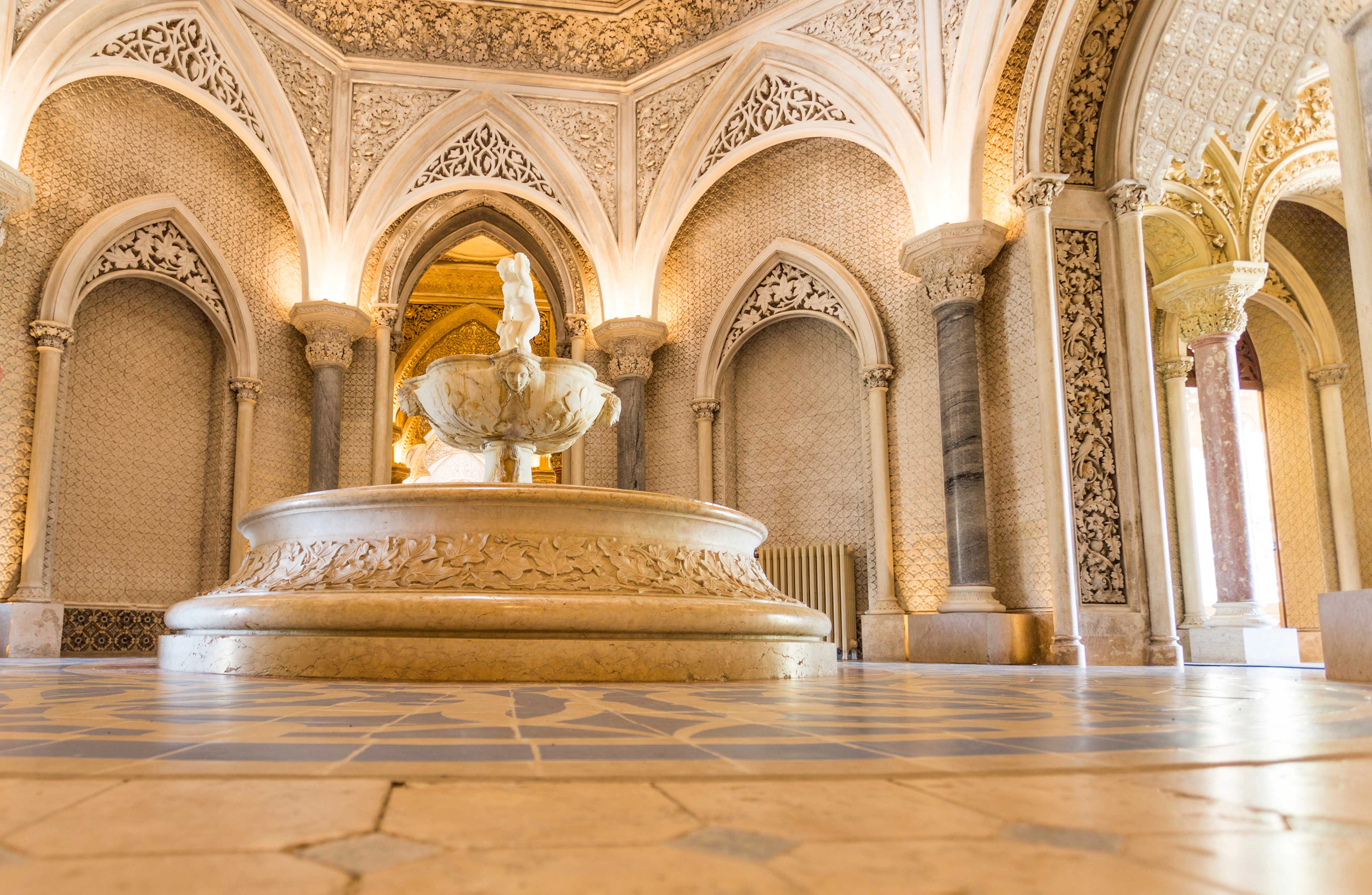 Monserrate Palace Central Gallery with ornate arches and central fountain.