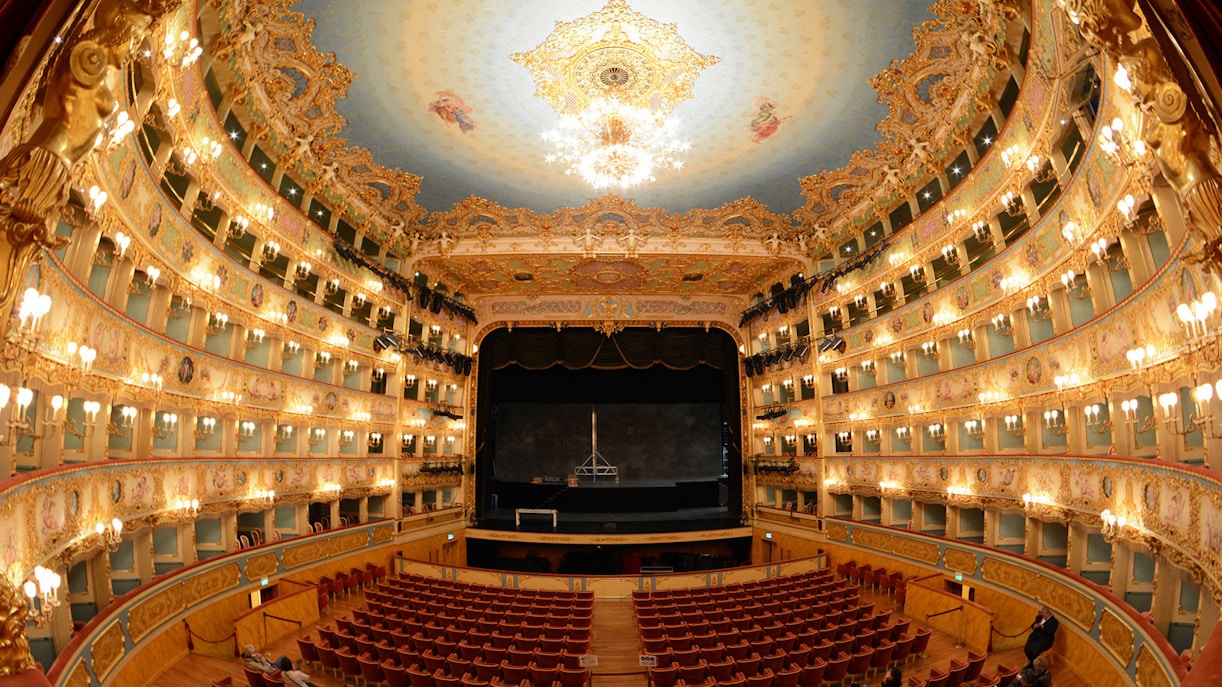 Interior view of Teatro La Fenice in Venice, showcasing ornate balconies and stage.