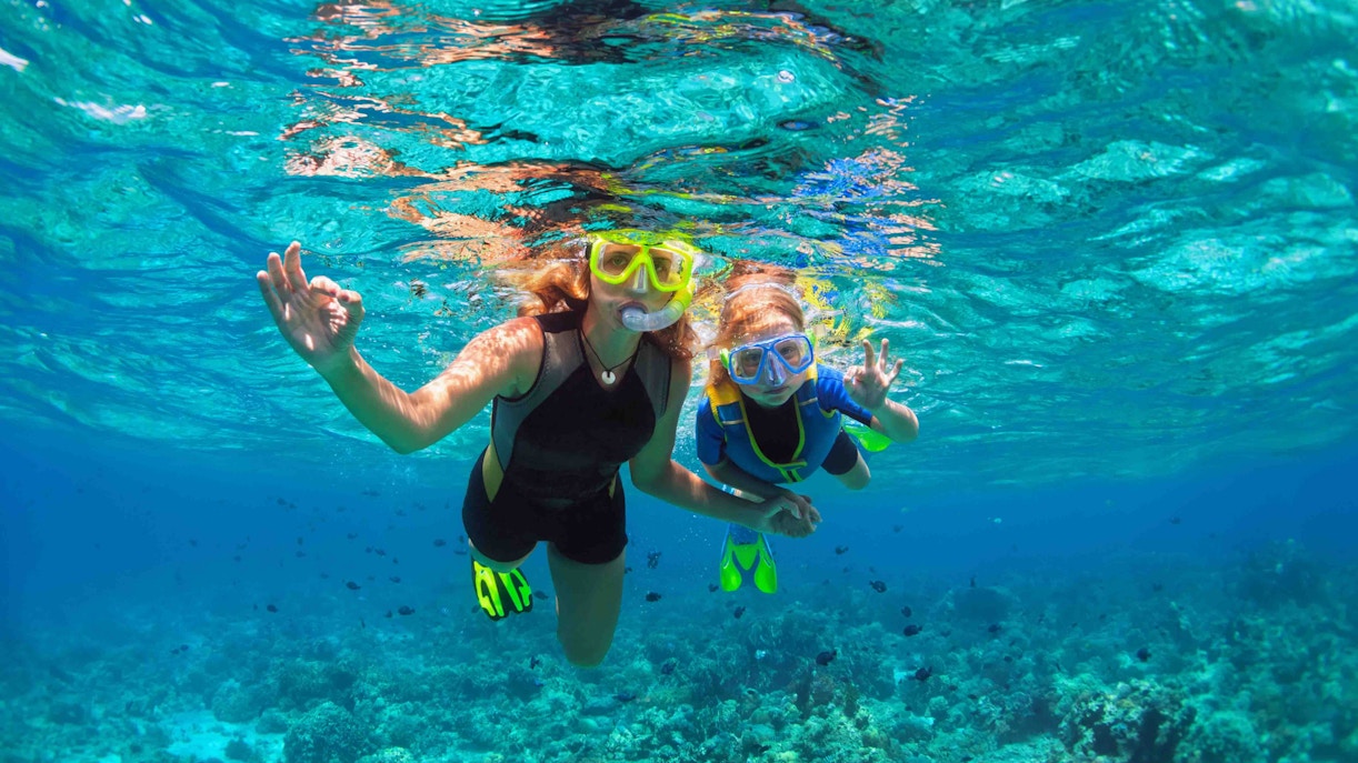 Tourists snorkelling in clear blue waters off Nusa Penida Island, Indonesia, showcasing unique underwater biodiversity