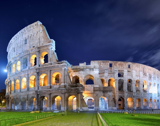 Colosseum illuminated at night in Rome, Italy, highlighting night tour experience.