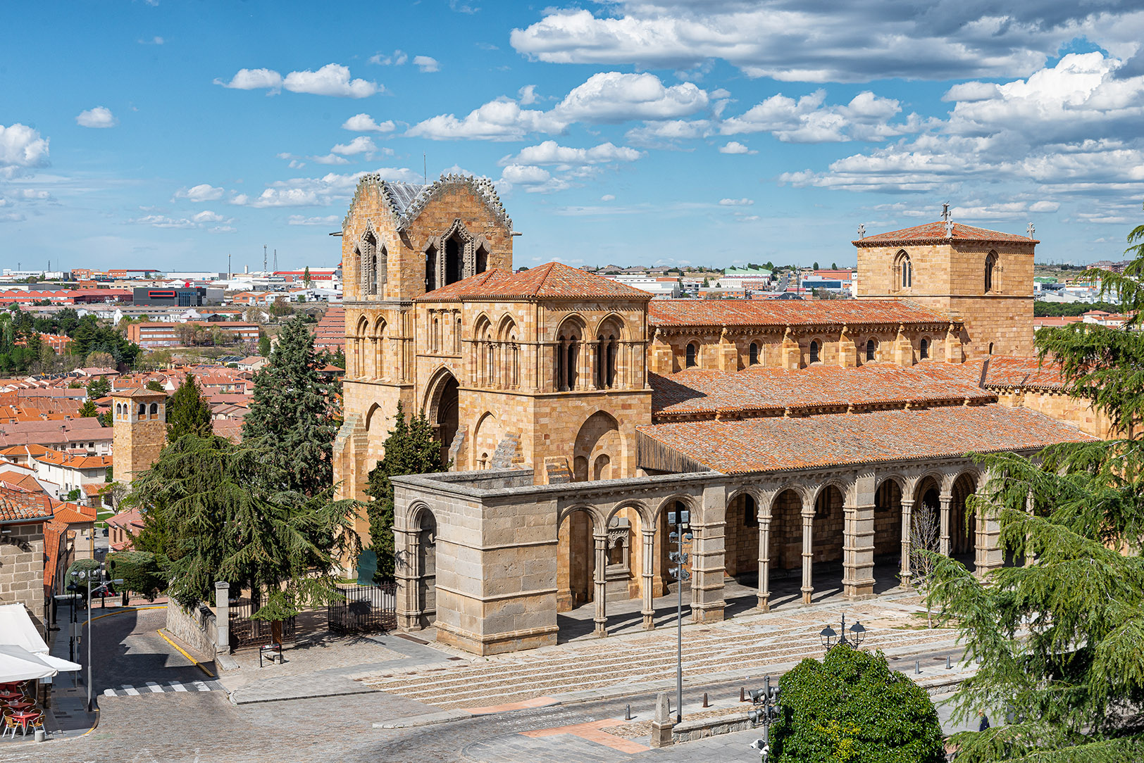 Basilica de San Vicente in Ávila, Spain, showcasing Romanesque architecture and arched colonnade.