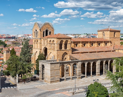Basilica de San Vicente in Ávila, Spain, showcasing Romanesque architecture and arched colonnade.