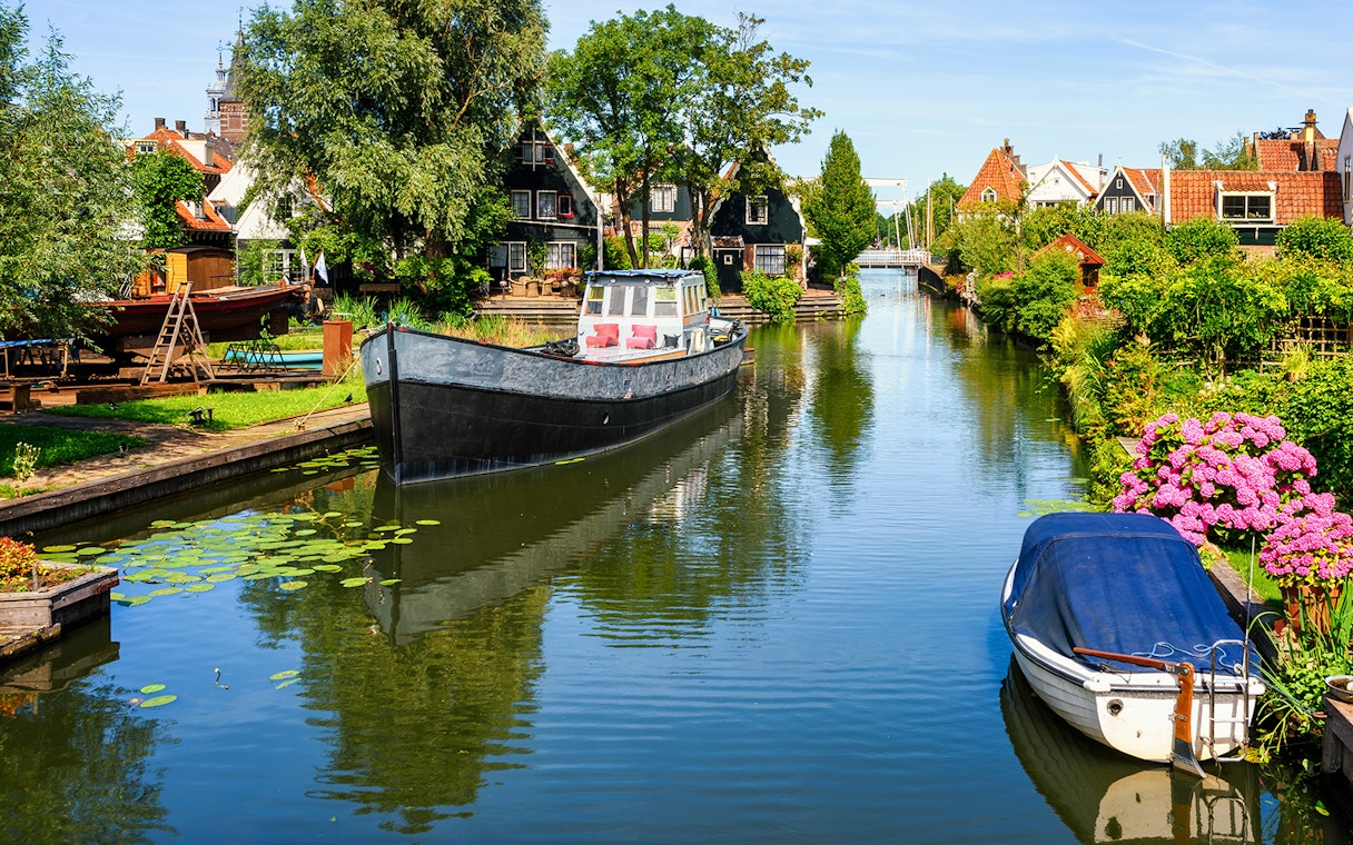 Canal view in Volendam with boats and traditional Dutch houses.