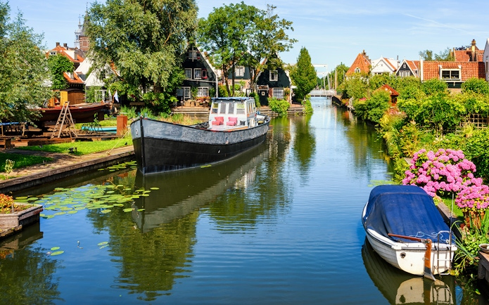 Canal view in Volendam with boats and traditional Dutch houses.