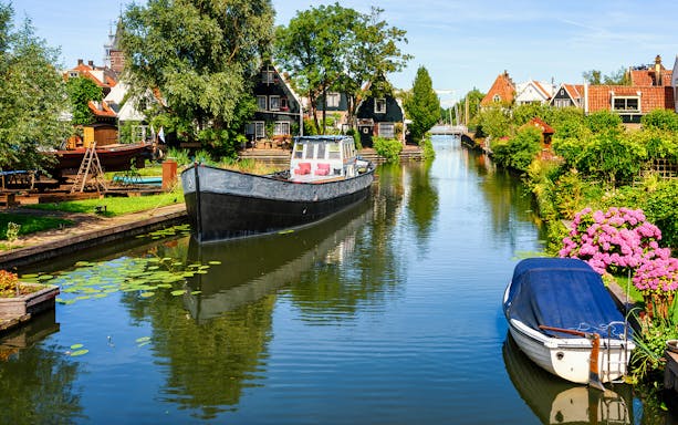 Canal view in Volendam with boats and traditional Dutch houses.