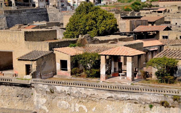 Herculaneum's House of the Deer with ancient Roman architecture and garden.