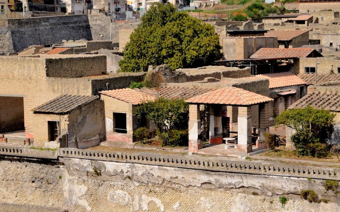 Herculaneum's House of the Deer with ancient Roman architecture and garden.