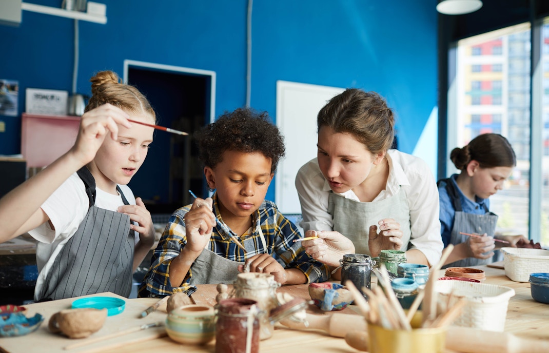 Children painting pottery at a workshop in Paris Aquarium.
