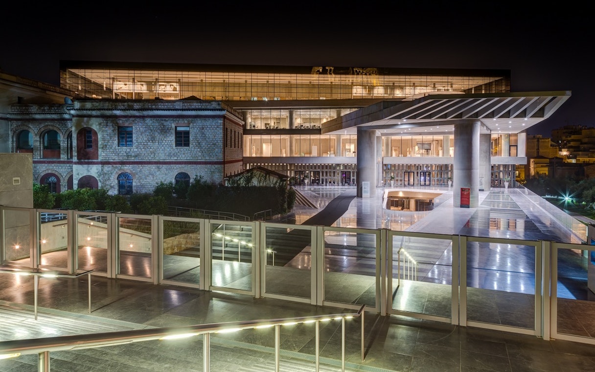 Acropolis Museum entrance illuminated at night, Athens, Greece.