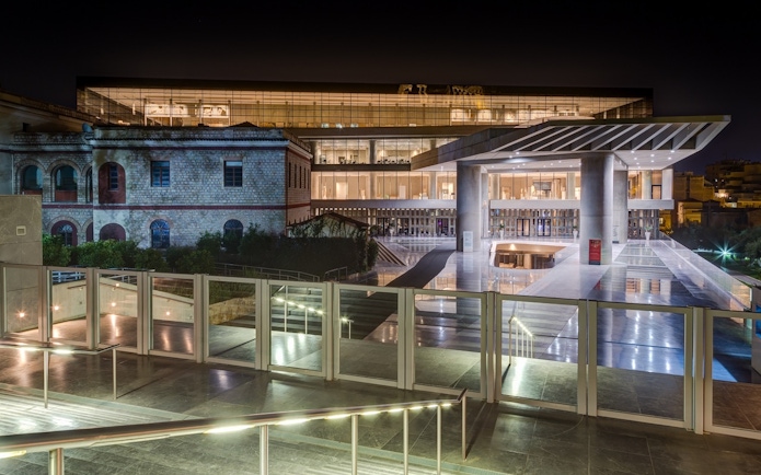 Acropolis Museum entrance illuminated at night, Athens, Greece.