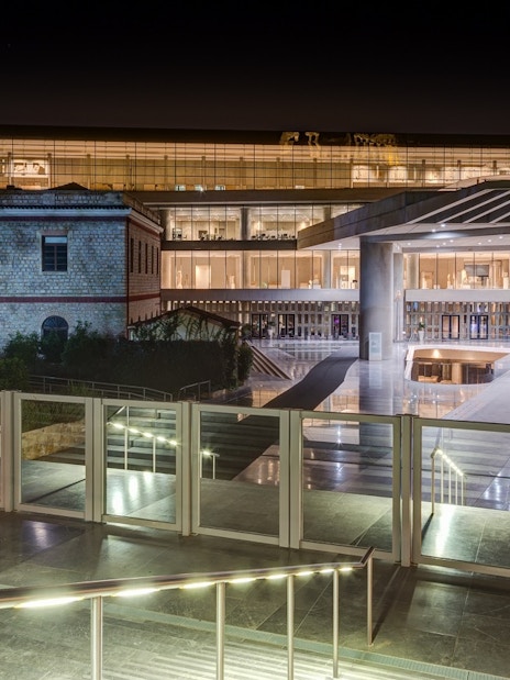 Acropolis Museum entrance illuminated at night, Athens, Greece.
