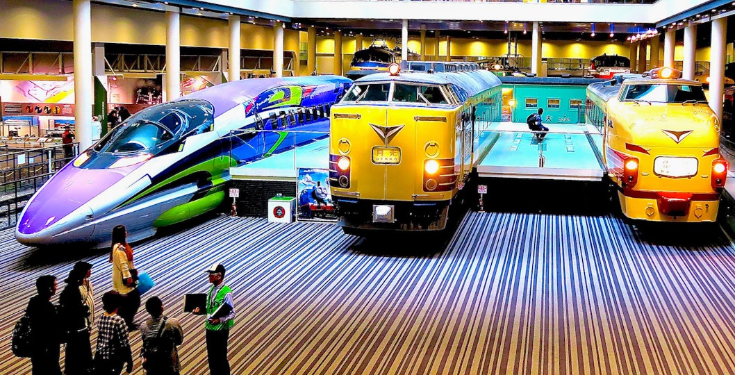 Visitors exploring exhibits at Kyoto Railway Museum, Japan.