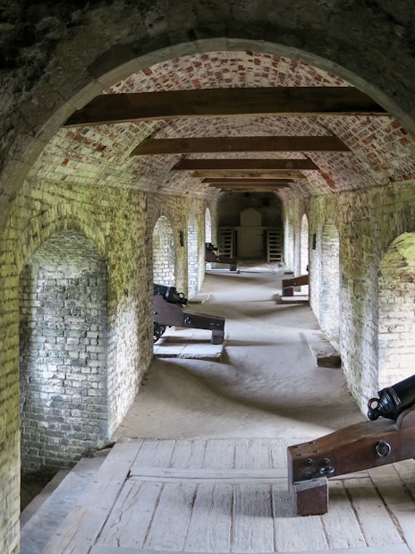 Dover Castle Secret Wartime Tunnels with historic cannons and arched brick passageways.