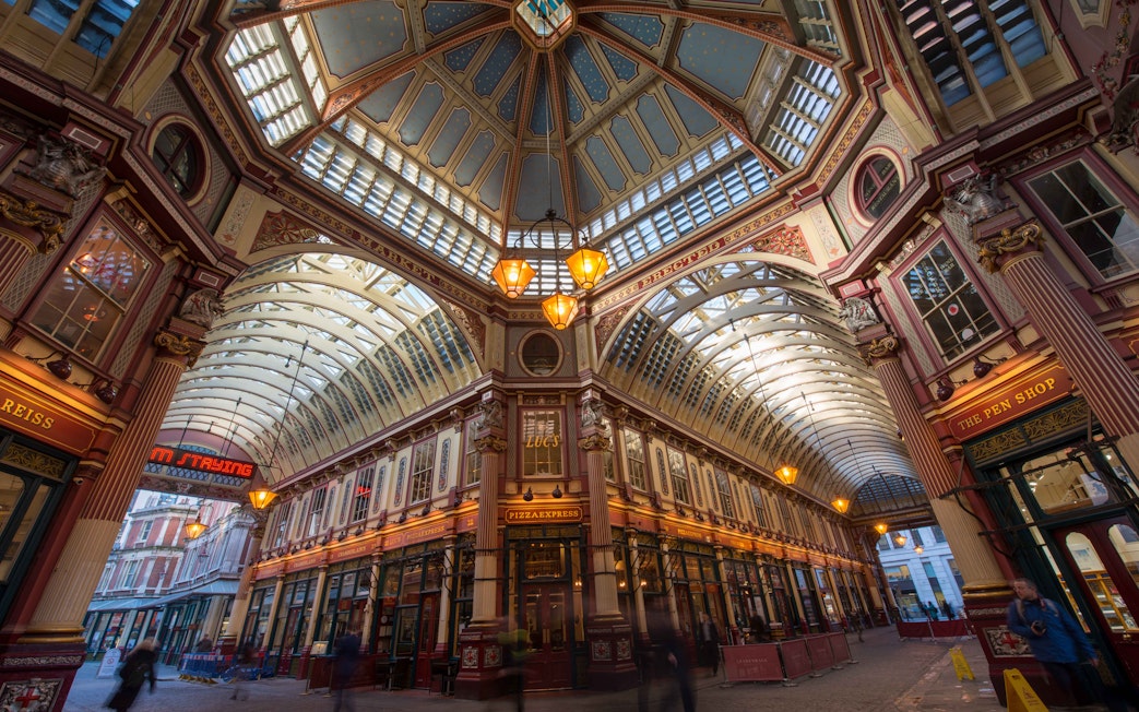 Leadenhall Market in London with ornate ceiling and bustling shops.